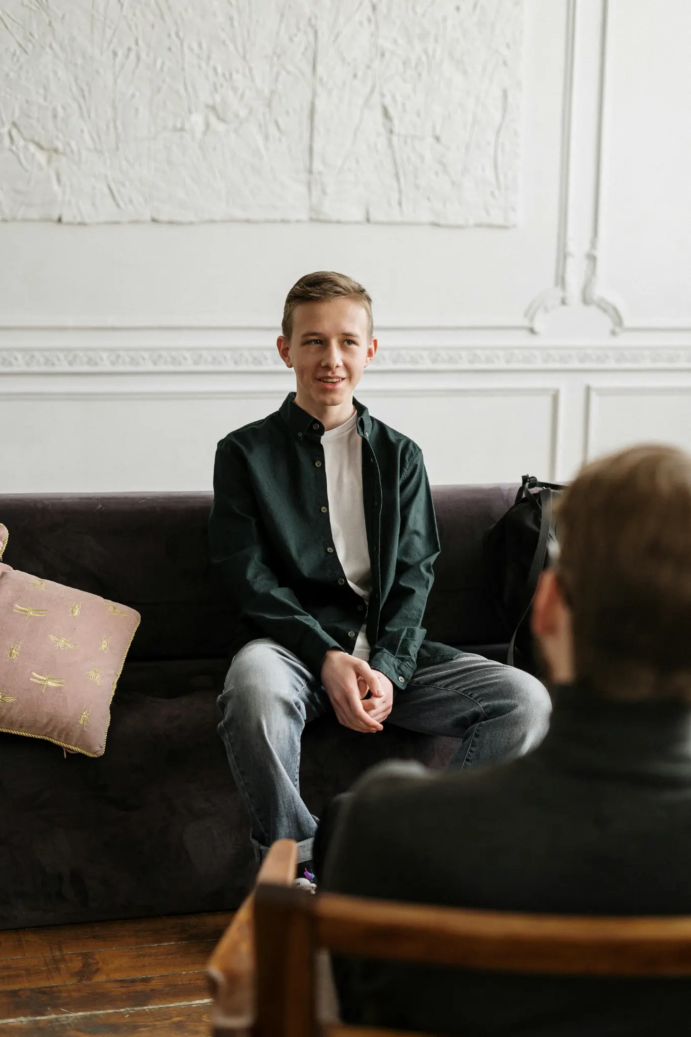 Individual therapy session — person seated on couch in therapy