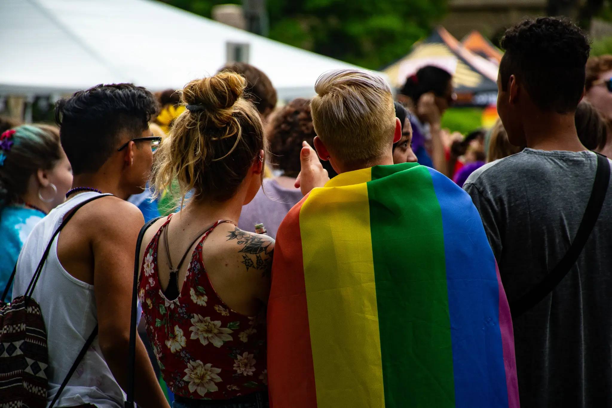 LGBTQ friends at Pride with rainbow flag